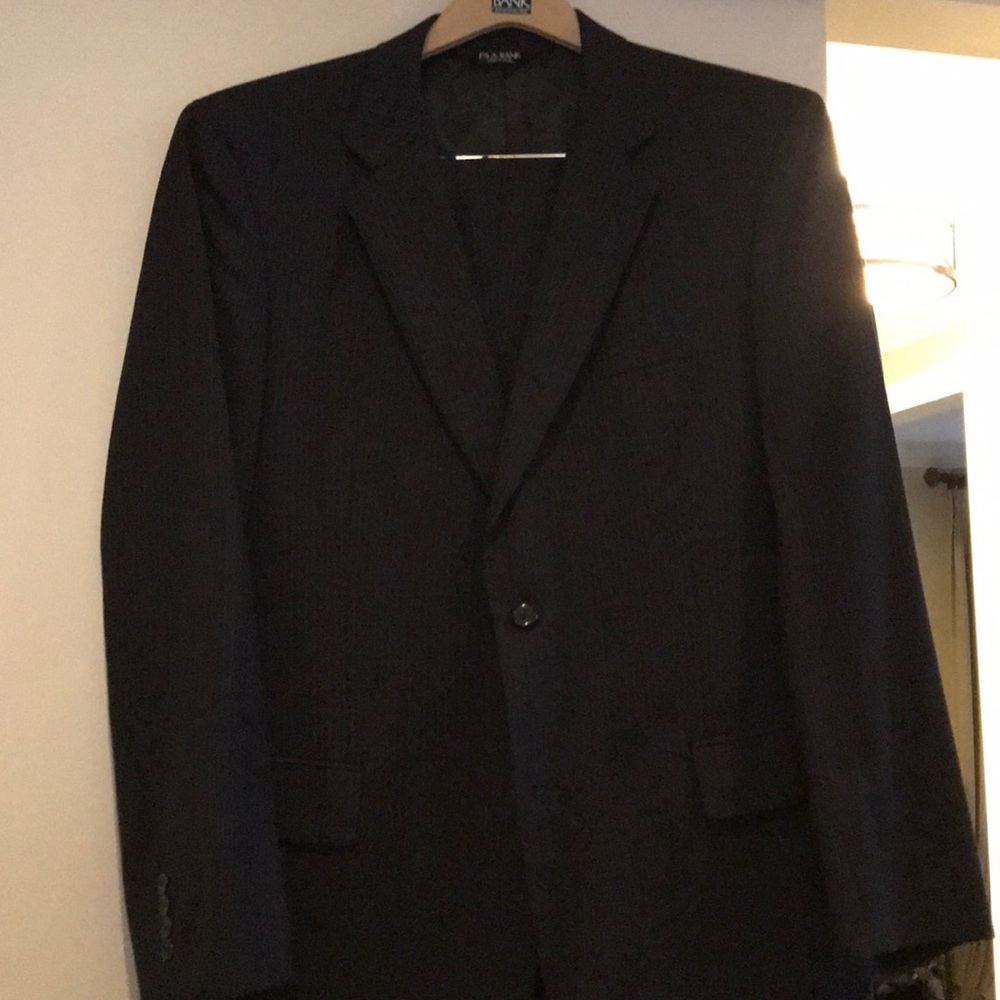 Jos A Bank. Men’s black suit, subtle pinstripe.